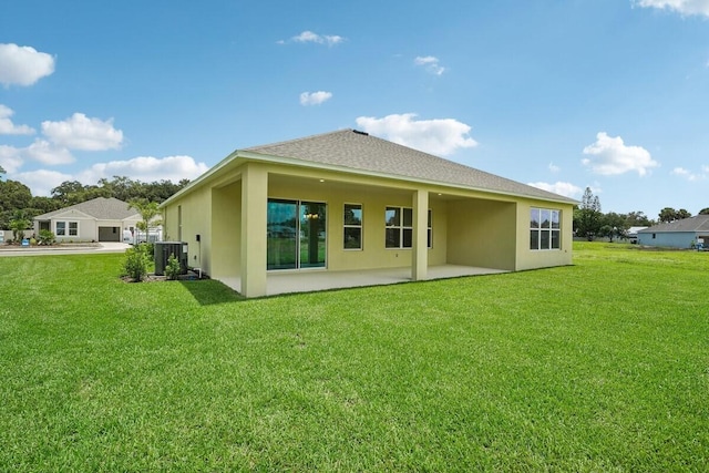 back of property with a yard and a patio area