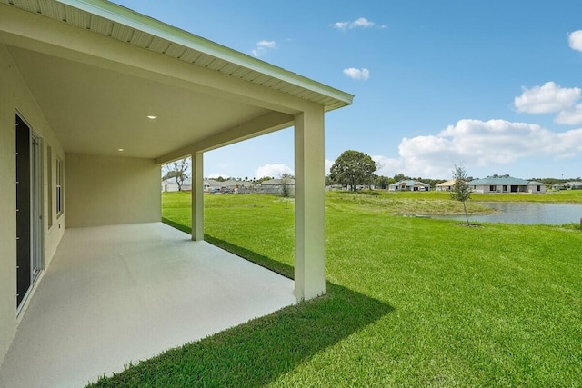 view of yard with a patio and a water view