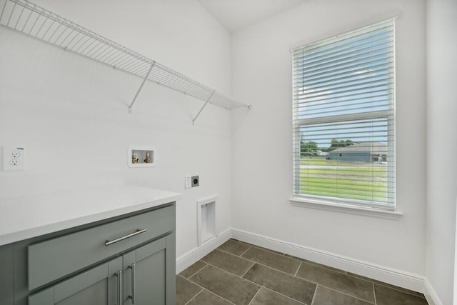 laundry area featuring hookup for a washing machine, cabinet space, baseboards, and hookup for an electric dryer