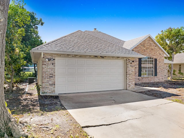 view of front of house featuring central AC unit and a garage