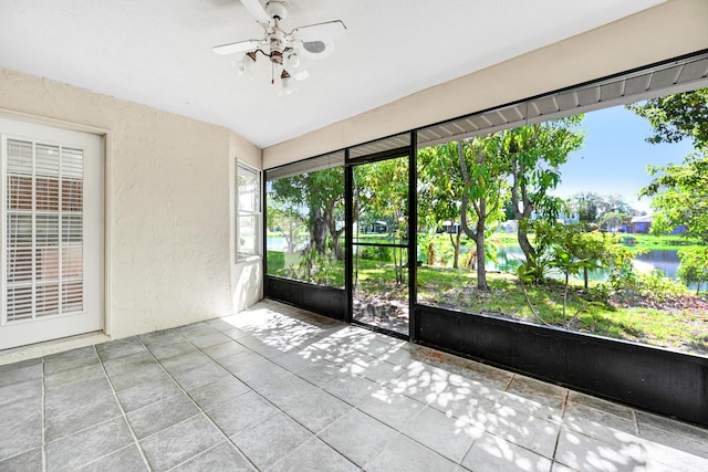 unfurnished sunroom with ceiling fan