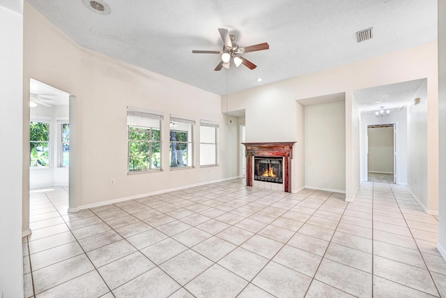 unfurnished living room with light tile patterned floors, plenty of natural light, and ceiling fan