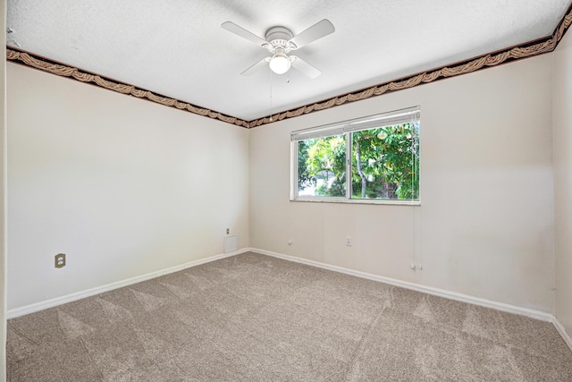 unfurnished room with carpet flooring, ceiling fan, and a textured ceiling