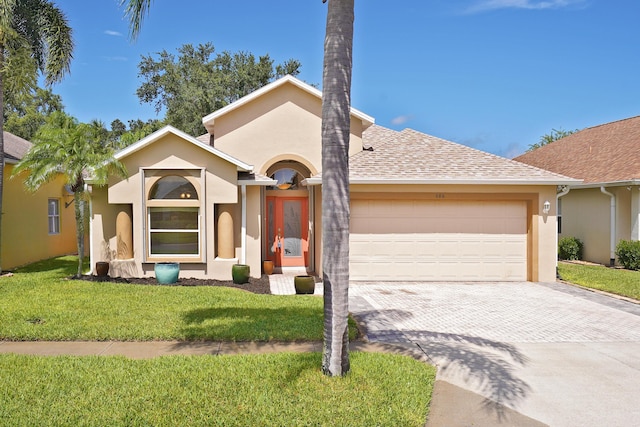 single story home featuring a garage and a front yard