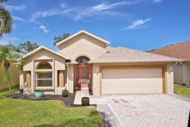 ranch-style home featuring a garage and a front yard