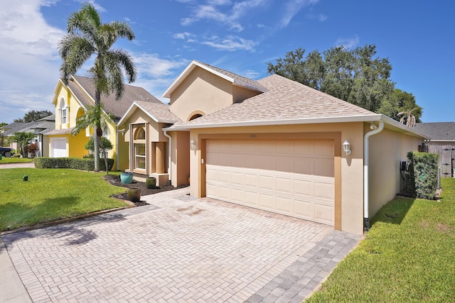 view of front of house with a garage and a front lawn