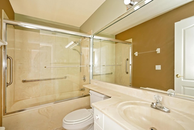 full bathroom with enclosed tub / shower combo, vanity, and toilet