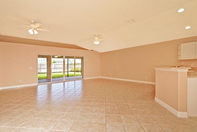 tiled empty room with lofted ceiling and ceiling fan