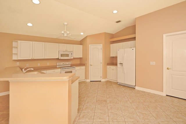 kitchen with white appliances, kitchen peninsula, sink, and white cabinets