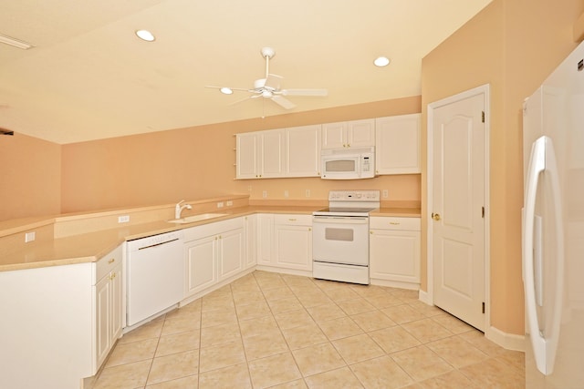 kitchen with sink, white appliances, light tile patterned floors, ceiling fan, and white cabinets