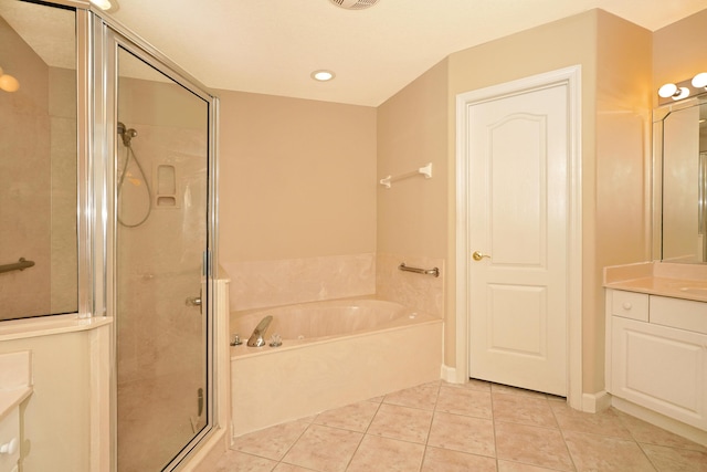 bathroom featuring vanity, shower with separate bathtub, and tile patterned flooring