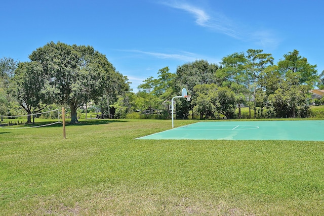 view of sport court with a lawn and volleyball court