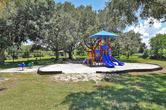 view of jungle gym with a lawn