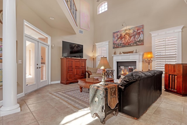 living room with french doors and a towering ceiling