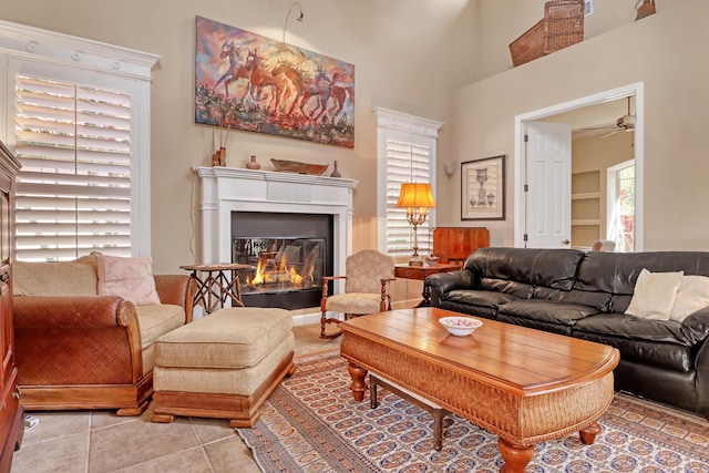 living room with light tile patterned floors and ceiling fan