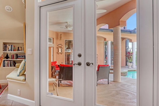 entryway featuring ceiling fan and french doors