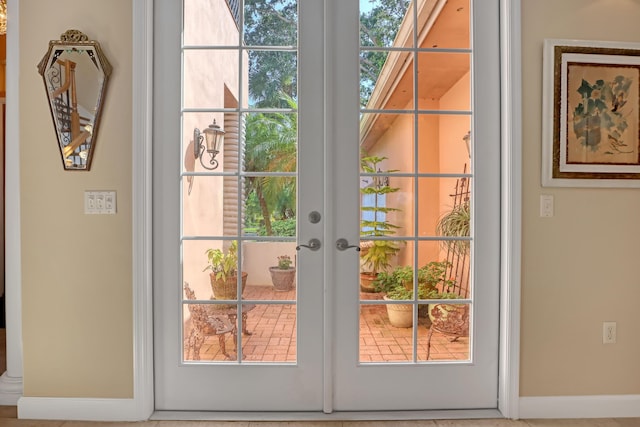 doorway to outside with french doors and a healthy amount of sunlight