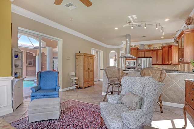 tiled living room featuring ceiling fan and ornamental molding