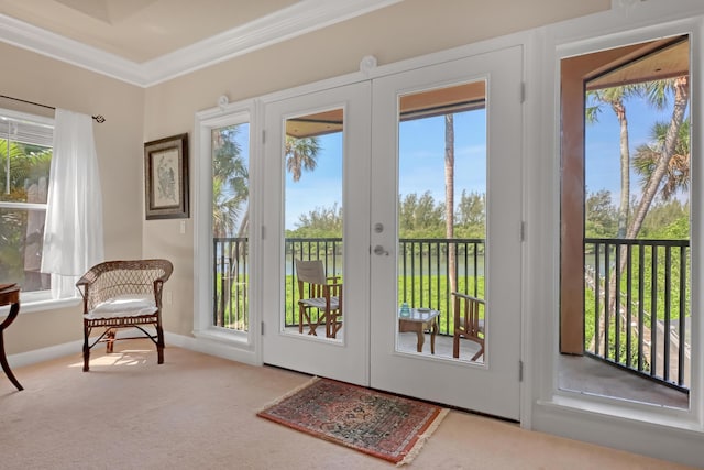 doorway to outside with carpet flooring, french doors, and crown molding