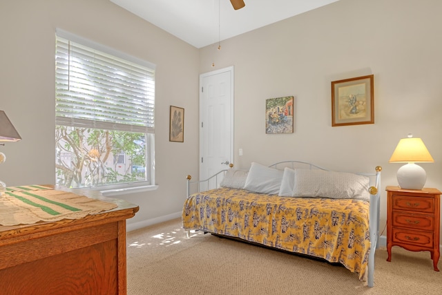 bedroom featuring ceiling fan and light carpet