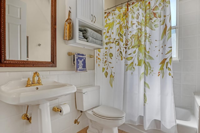 full bathroom featuring sink, shower / tub combo, tile walls, and toilet