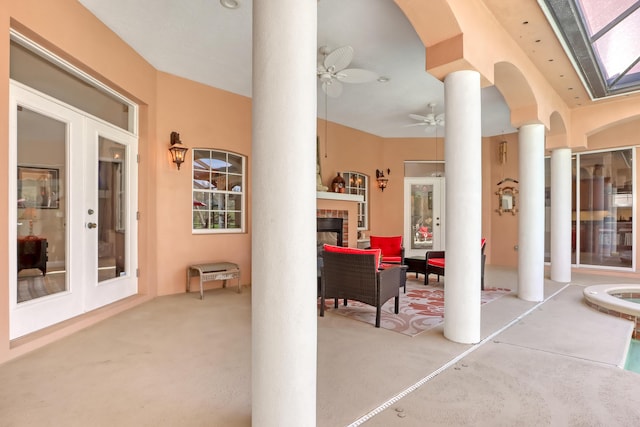 view of patio featuring ceiling fan, french doors, and an outdoor living space