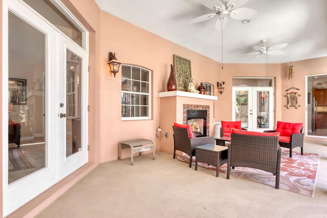 living room with carpet flooring, french doors, and ceiling fan