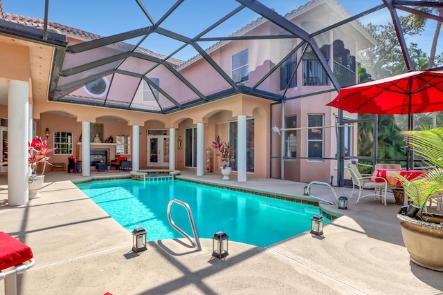 view of pool with a patio and glass enclosure