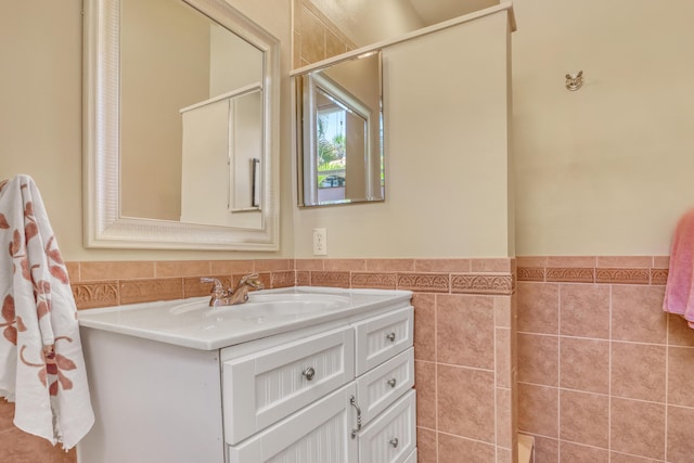 bathroom with vanity and tile walls