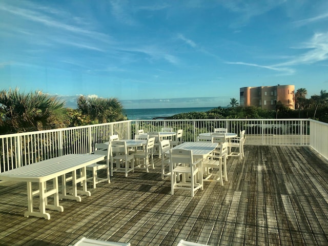 wooden terrace featuring a water view