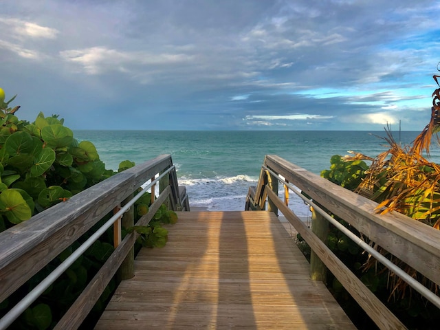 surrounding community featuring a water view and a view of the beach