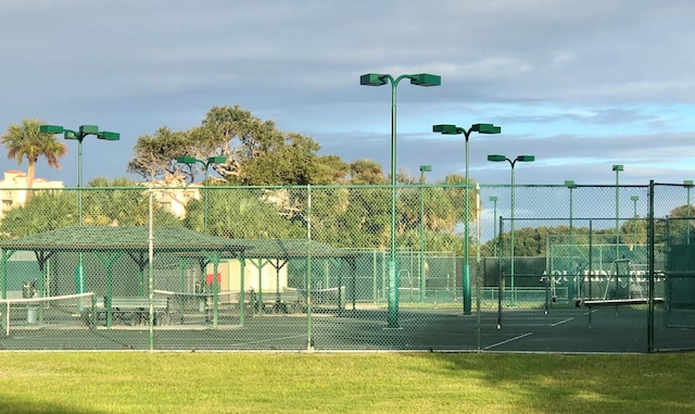 view of sport court with a yard