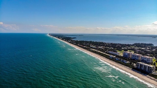 drone / aerial view with a water view and a view of the beach