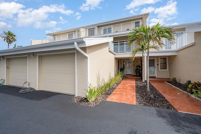 townhome / multi-family property with a balcony and a garage