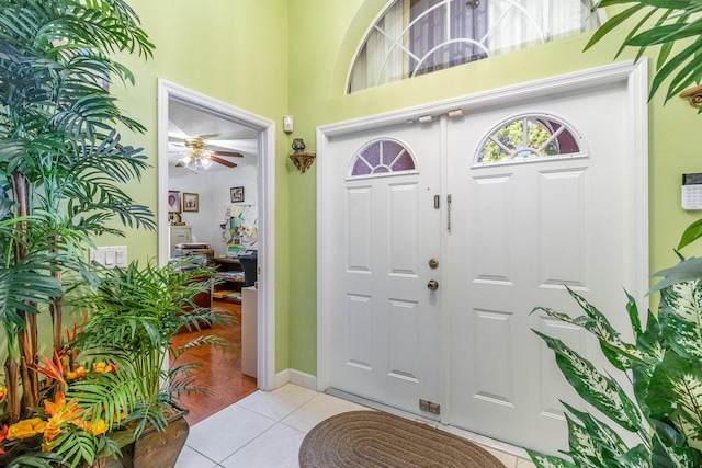 entryway with ceiling fan and tile floors