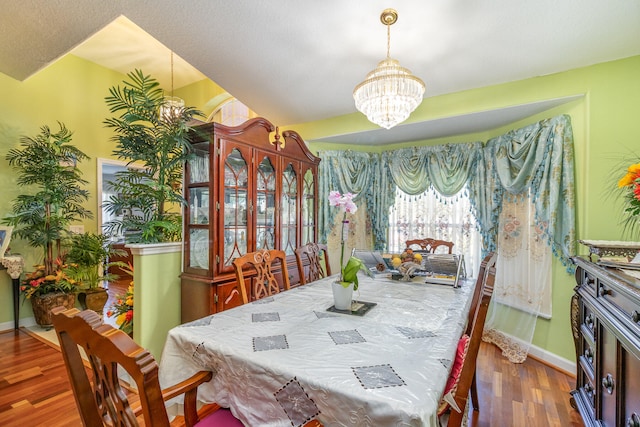 dining space with a chandelier and dark hardwood / wood-style floors