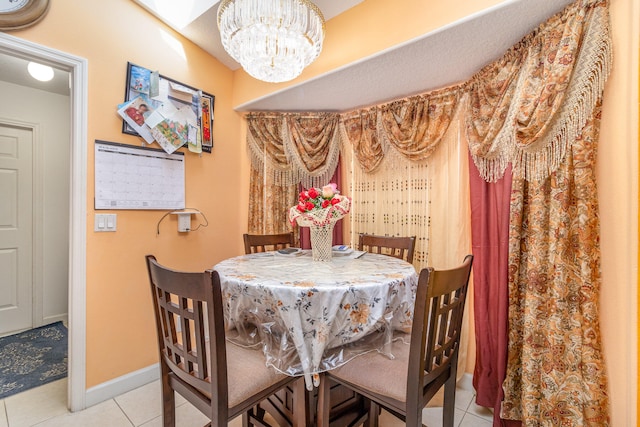 dining space featuring tile floors and a chandelier