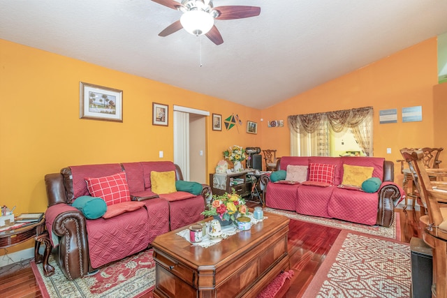 living room with ceiling fan, vaulted ceiling, and hardwood / wood-style flooring