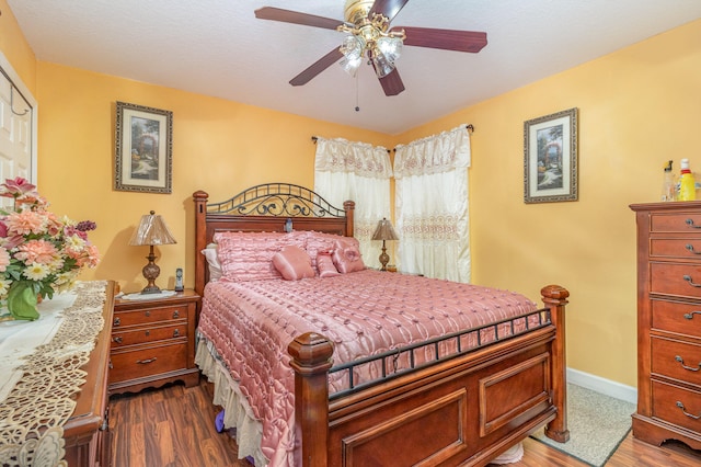 bedroom featuring dark wood-type flooring and ceiling fan