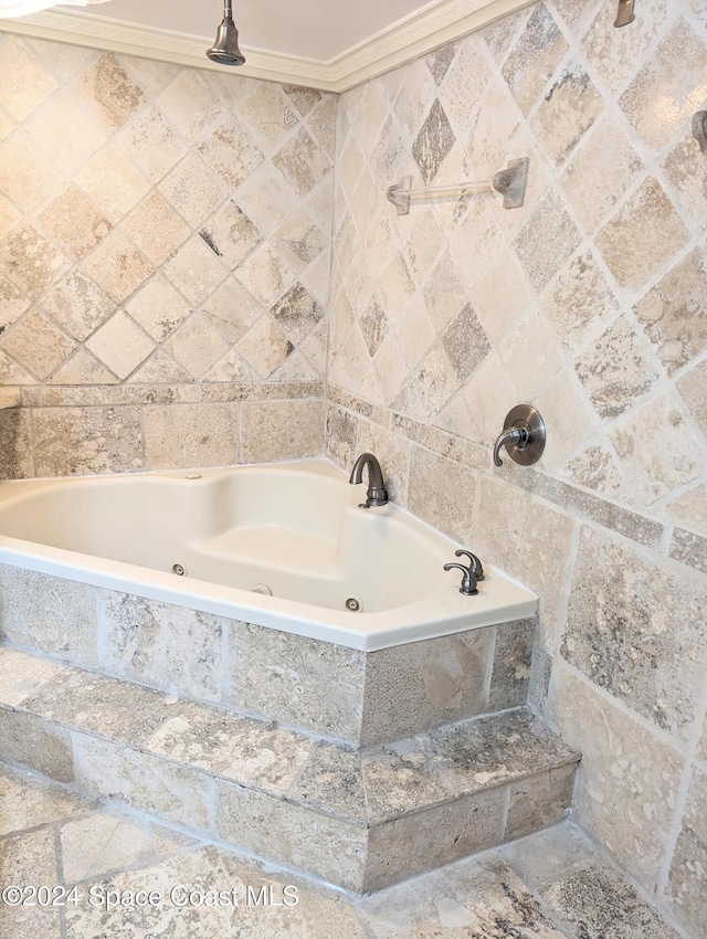 bathroom featuring tiled bath and crown molding