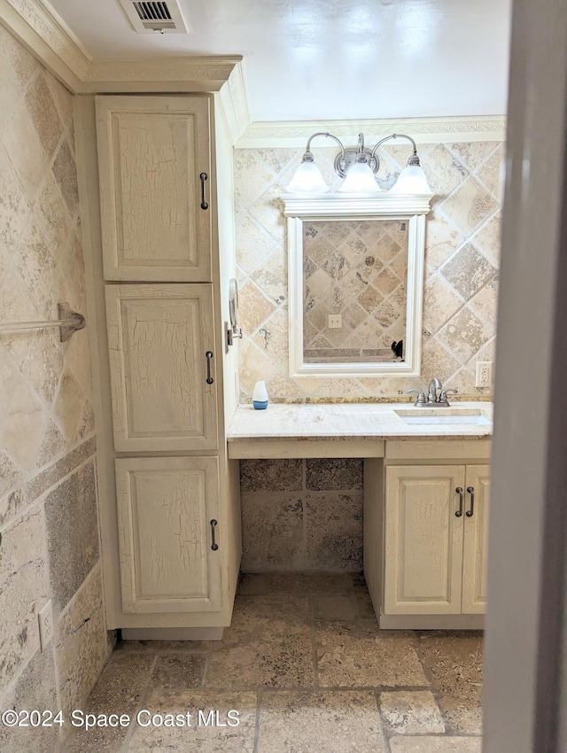 bathroom with vanity and ornamental molding