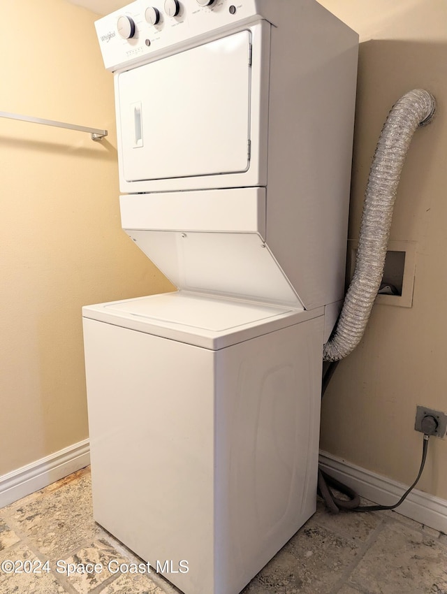 washroom featuring stacked washer and clothes dryer