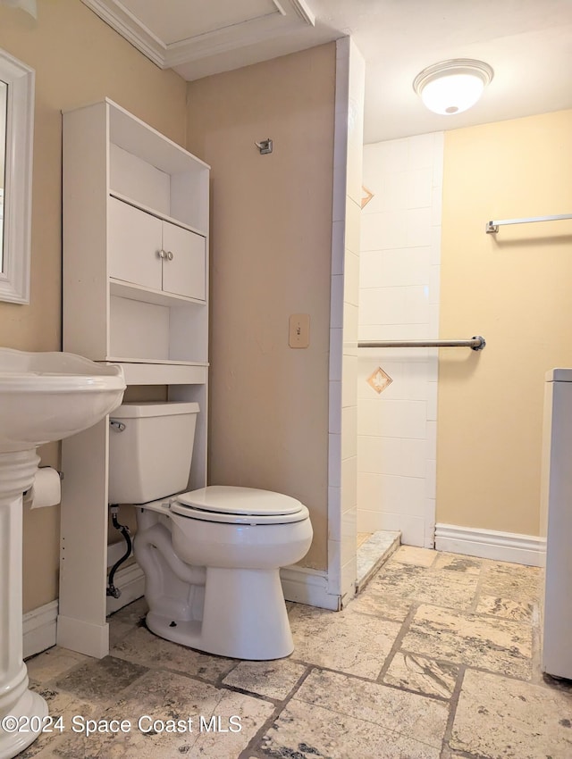 bathroom with toilet and ornamental molding