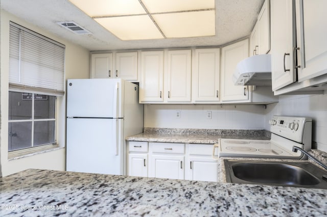 kitchen with white cabinets, decorative backsplash, white appliances, and sink