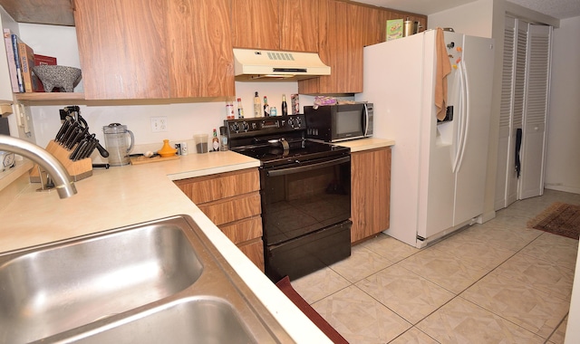 kitchen with light tile patterned flooring, white fridge with ice dispenser, sink, and black electric range