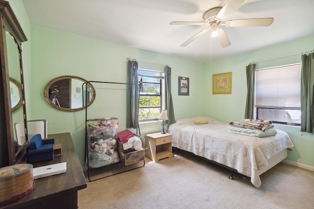 bedroom featuring light carpet and ceiling fan