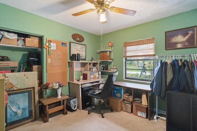 carpeted office featuring ceiling fan