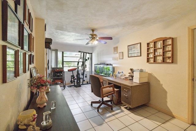 tiled office featuring a textured ceiling and ceiling fan