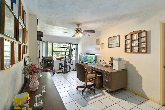 tiled office space featuring ceiling fan