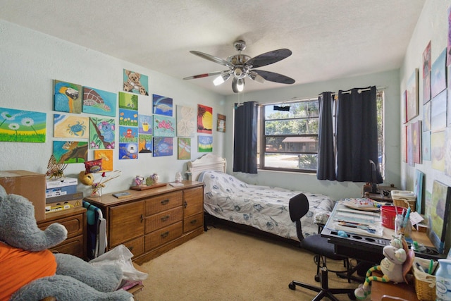 carpeted bedroom featuring a textured ceiling and ceiling fan